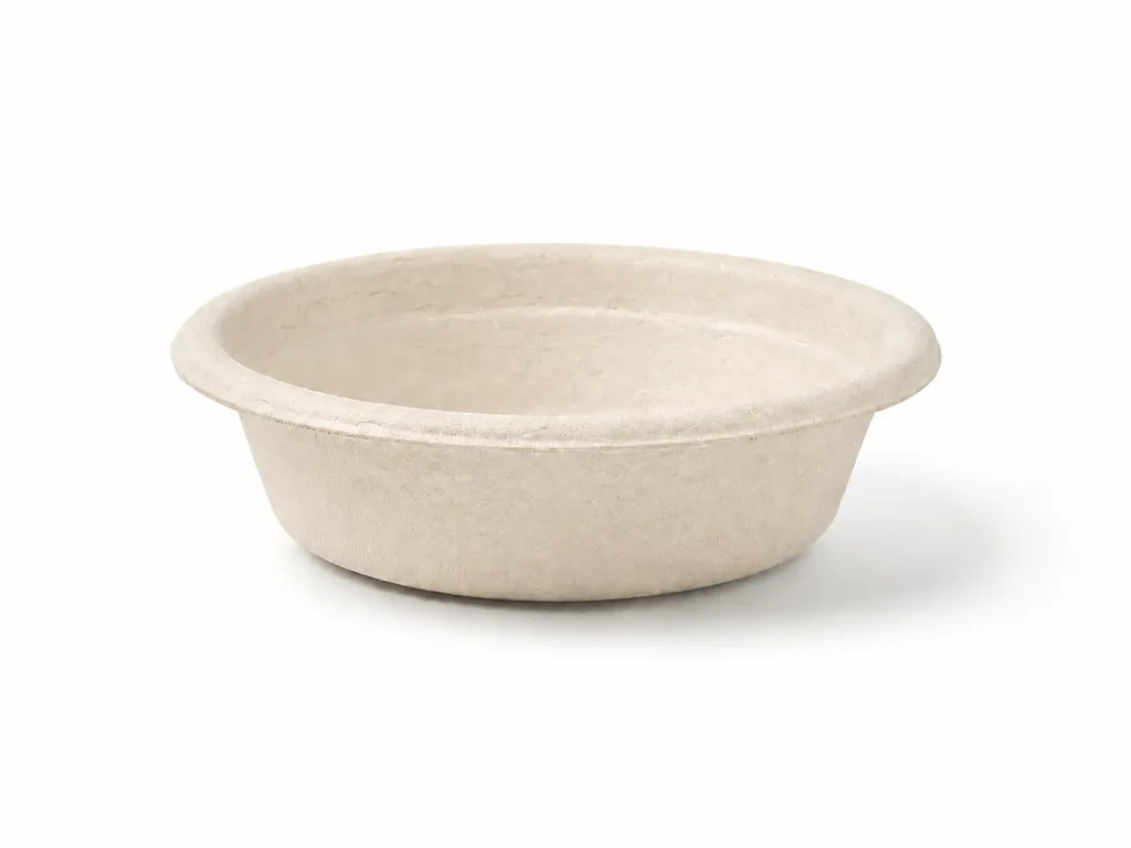 Angled front view of a natural-color 1oz Molded Fiber Sauce Cup showing its round opening, flanged rim, shallow tapered wall, and molded-fiber texture