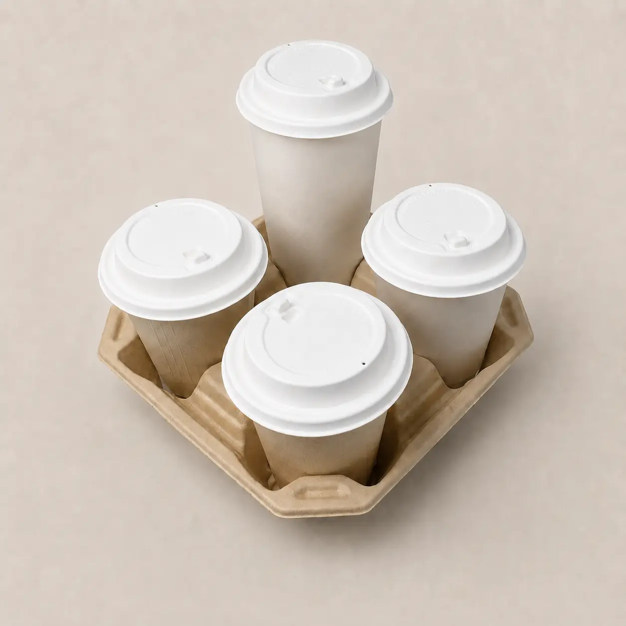 90mm Flip-Top Molded Fiber Hot Cup Lids in Four-Cup Carrier Four takeaway cups fitted with white 90mm flip-top molded fiber hot cup lids in a molded fiber four-cup drink carrier
