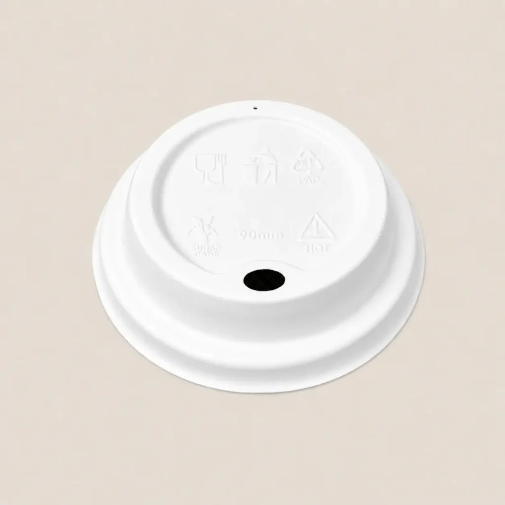Front angled view of a white 90mm molded fiber hot cup sip lid with a fixed drinking opening and separate vent hole