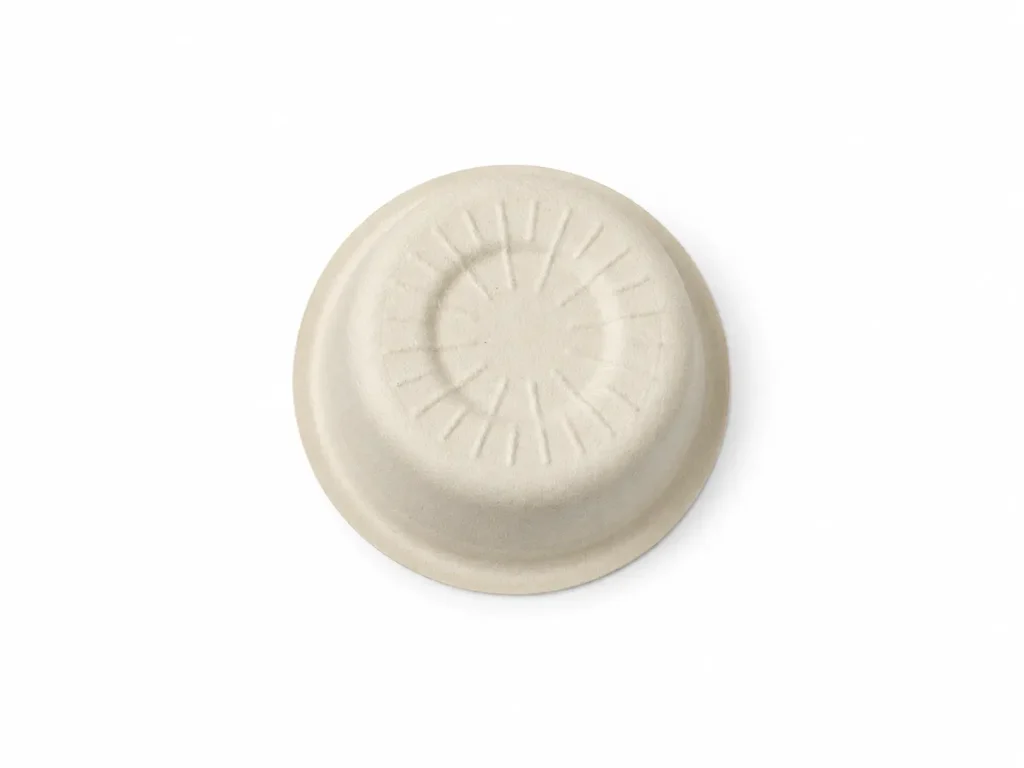 Bottom view of a natural-color 1oz Molded Fiber Sauce Cup showing its circular base, radial reinforcing texture, tapered wall, and molded rim